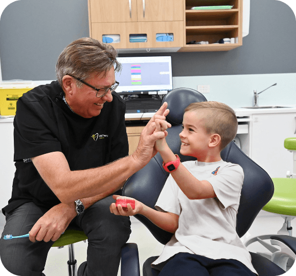 dr rene with child patient in comfort dental buderim