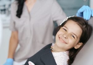 childre's dental appointment happy girl in dentist chair