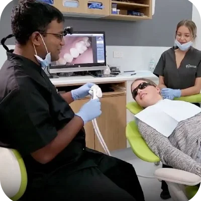 image of a dentist and assistant that explain about procedure and a girl wearing black glass